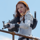 Scarlett Johansson's Black Widow wears her white superhero suit while holding a machine gun in her recent solo film.